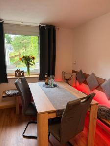 a dining room with a table and a couch at Naturhof Kluge in Saupsdorf