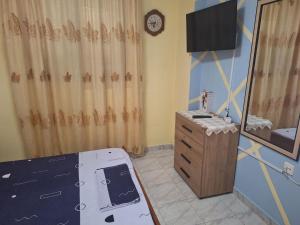 a room with a stove and a mirror and a tv at Vangel Garden in Agios Nikolaos