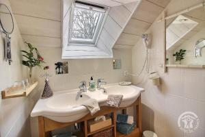 a bathroom with a sink and a mirror at La Guyonnais Chambre d'hôtes in Quévert +9 photos