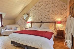 a bedroom with a large bed in a attic at La Guyonnais Chambre d'hôtes in Quévert