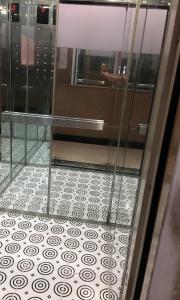 a glass door with a tile floor in a room at Hoang Nam Hotel in Ho Chi Minh City