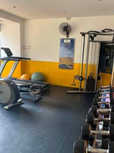 a gym with a row of exercise bikes and a treadmill at Nam Talay Condo Monthly only in Na Jomtien