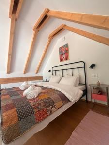 a bedroom with a large bed in the attic at Tiny Folk in Gărâna