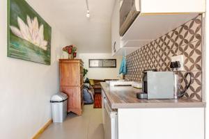 a kitchen with a counter top with a microwave at Beachfront Bliss in Cape Town