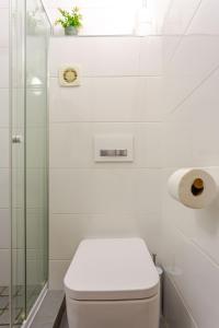 a bathroom with a toilet and a glass shower at Beachfront Bliss in Cape Town +18 photos