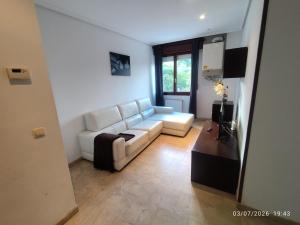 a living room with a white couch and a table at BAKEA in Bermeo