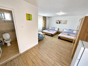 a small room with two beds and a bathroom at Casa Olimpia 2 Mai in 2 Mai