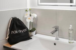 a black bag sitting on top of a sink at Tower Hotel Frankfurt in Frankfurt