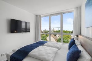 a bedroom with a bed and a large window at Tower Hotel Frankfurt in Frankfurt