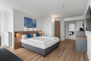 a bedroom with a large bed with blue pillows at Tower Hotel Frankfurt in Frankfurt