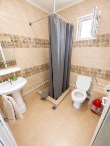 a bathroom with a shower and a toilet and a sink at Casa Olimpia 2 Mai in 2 Mai +39 photos
