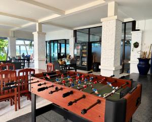 a billiard table in a room with a table at Sunset Beach Villas in Haad Rin