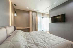 a bedroom with a bed and a flat screen tv at Skyline Grand Hotel - Near IGI New Delhi Airport in New Delhi