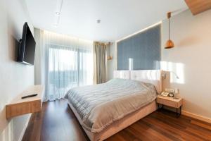 a bedroom with a large bed and a large window at Skyline Grand Hotel - Near IGI New Delhi Airport in New Delhi +18 photos