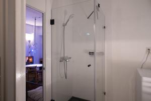 a bathroom with a shower with a glass door at apartment hotel Tasu Toco room 2 in Kichijōji