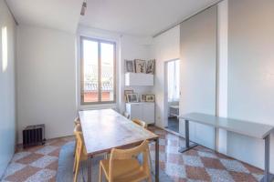 a kitchen with a table and chairs in a room at Nel Ghetto, Bologna by Short Holidays in Bologna