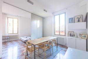a dining room with a wooden table and chairs at Nel Ghetto, Bologna by Short Holidays in Bologna