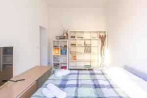 a bedroom with a bed and a book shelf at Nel Ghetto, Bologna by Short Holidays in Bologna
