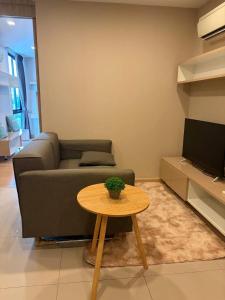 a living room with a couch and a table at CONDO UNIT With BALCONY in Bangkok