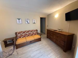 a living room with a couch and a flat screen tv at Alloggio valle stura in Vinadio