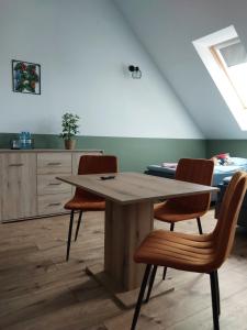 a dining room with a table and two chairs at WINNICA 61 - Pokoje in Krotoszyce