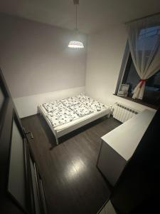 a bedroom with a bed in the corner of a room at Izdebka in Bochowo