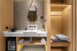 a bathroom with a sink and a mirror at Atour on the Bund in Shanghai +25 photos