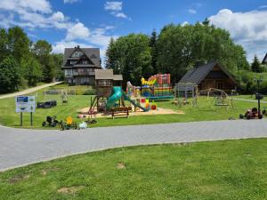 a playground in front of a house with a park at Willa Zielona Polana in Czarna Góra