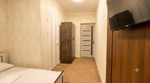 a small room with a bed and a closet at Hotel Usmoon in Tashkent