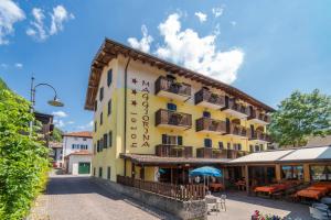 a building with a sign on the side of it at Albergo Maggiorina in Ledro