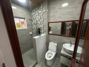 a bathroom with a toilet and a sink at Casa Gutierrez in Lingayen +18 photos