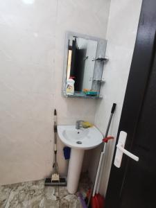 a bathroom with a sink and a mirror at Levani Cottages in Ureki +9 photos
