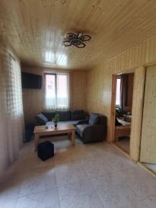 a living room with a couch and a table at Levani Cottages in Ureki