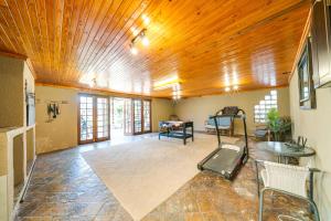 a large living room with a wooden ceiling and chairs at 18 Goethe in Secunda