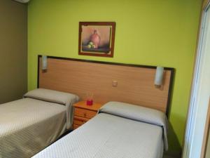 Postel nebo postele na pokoji v ubytování Hostal DS