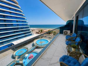 a balcony with two hot tubs on the beach at WHITE TITANIC LUXURY Sea View & Studios in Mamaia Sat/Năvodari