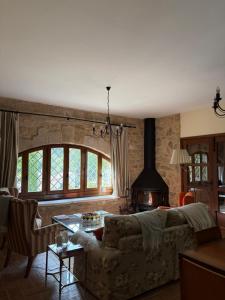 a living room with a couch and a stove at Villa Natalia in Monroyo