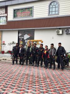 a group of men standing in front of a building at Apni Haveli Hotel and Restuarant in Bhojpur