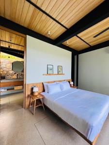 a bedroom with a large bed and a wooden ceiling at The Sevana in Talalla South +45 photos