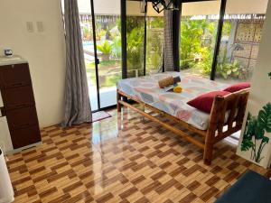 a bedroom with a bed and a wooden floor at La Provinzia Exclusive Use - 3 Air-Conditioned Rooms 3 Fan Cooled Huts Good for 12 People in Camotes Islands +46 photos