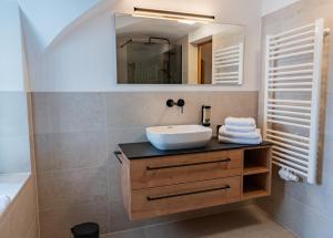 a bathroom with a sink and a mirror at N47 Apartments Berchtesgaden in Berchtesgaden +31 photos