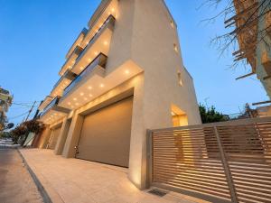 a building with two garage doors on a street at AGORA luxury APARTMENT 3 in Loutraki