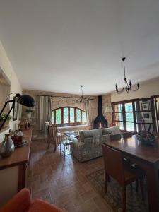 a living room with a couch and a table at Villa Natalia in Monroyo +10 photos