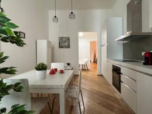 a kitchen and dining room with a white table at Porta Nova, Bologna by Short Holidays in Bologna