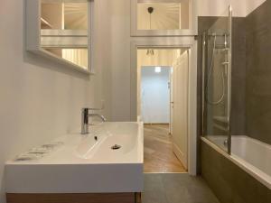 a white bathroom with a sink and a shower at Porta Nova, Bologna by Short Holidays in Bologna +14 photos