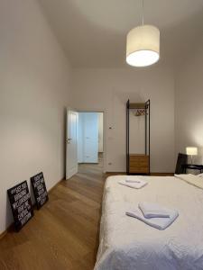 a bedroom with a large bed with two towels on it at Porta Nova, Bologna by Short Holidays in Bologna