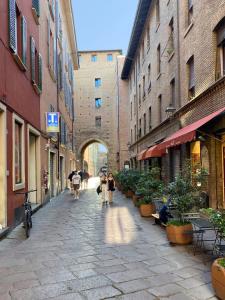 a group of people walking down a street at Porta Nova, Bologna by Short Holidays in Bologna