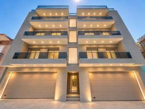 a large apartment building with two garage doors at AGORA luxury APARTMENT 3 in Loutraki