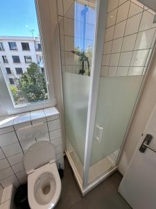 a bathroom with a toilet and a shower at La lumière d'Issy in Vanves