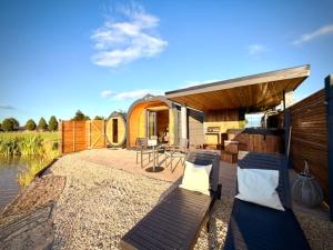 a house with a patio with a table and chairs at New Farm Cheshire Holidays in Winsford